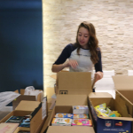 Emily fills the military gift boxes with all the items. 150x150 USO Military Care Packages